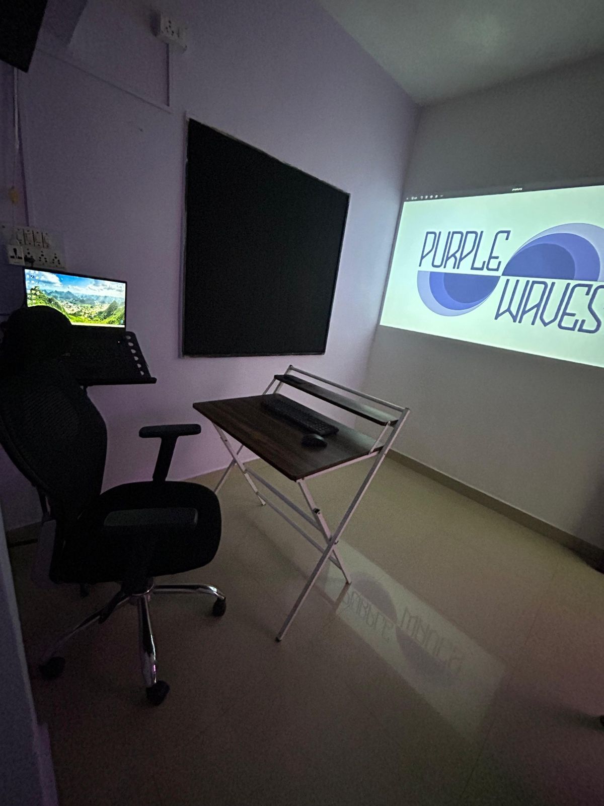 Second room with chair, desk and projector